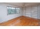 Living room with built-in shelving and hardwood floors at 218 Kingsway Cir, Charlotte, NC 28214