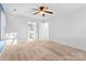 Well-lit bedroom with carpet, ceiling fan and access to bathroom at 2512 Heathershire Ln, Matthews, NC 28105