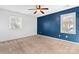 Spacious bedroom with blue accent wall, carpet, and ceiling fan at 2512 Heathershire Ln, Matthews, NC 28105