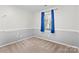 Small bedroom with window and blue curtains at 2512 Heathershire Ln, Matthews, NC 28105