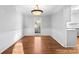 Bright dining room with hardwood floors and wainscoting at 2512 Heathershire Ln, Matthews, NC 28105