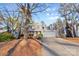 Two-story house with a large driveway and mature trees in the front yard at 2512 Heathershire Ln, Matthews, NC 28105