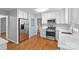 Updated kitchen with stainless steel appliances and light wood floors at 2512 Heathershire Ln, Matthews, NC 28105