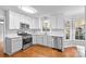 Modern kitchen with white cabinets, stainless steel appliances, and hardwood floors at 2512 Heathershire Ln, Matthews, NC 28105