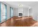 Spacious living room featuring hardwood floors and a brick fireplace at 2512 Heathershire Ln, Matthews, NC 28105