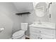 Clean powder room with a white vanity and a round mirror at 2512 Heathershire Ln, Matthews, NC 28105