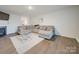 Living room with L-shaped sofa, fireplace and hardwood floors at 2643 Idared Dr, Dallas, NC 28034