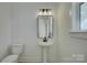 Simple bathroom with pedestal sink, toilet, and mirror at 2712 Yellow Bell Way, Monroe, NC 28112