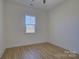 Simple bedroom with wood flooring and window at 2712 Yellow Bell Way, Monroe, NC 28112