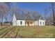 White farmhouse exterior with a gray roof and wooden porch columns at 2712 Yellow Bell Way, Monroe, NC 28112