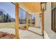 Spacious front porch with wooden posts and a view of the backyard at 2712 Yellow Bell Way, Monroe, NC 28112