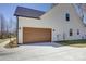 Attached garage with light brown door and concrete driveway at 2712 Yellow Bell Way, Monroe, NC 28112