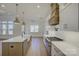 Spacious kitchen with white cabinets, a large island, and stainless steel appliances at 2712 Yellow Bell Way, Monroe, NC 28112