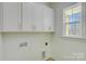 Laundry room with white cabinets and window at 2712 Yellow Bell Way, Monroe, NC 28112