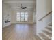 Open living room with hardwood floors, fireplace, and large windows at 2712 Yellow Bell Way, Monroe, NC 28112