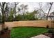 Landscaped backyard with a wooden fence and grassy area at 308 Dover Ave, Charlotte, NC 28209