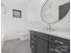 Bathroom with gray vanity, white toilet and hexagon tile floor at 308 Dover Ave, Charlotte, NC 28209