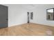 Bedroom with hardwood floors, gray door and ceiling fan at 308 Dover Ave, Charlotte, NC 28209