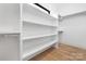 Bright walk-in closet with built in shelves and rods at 308 Dover Ave, Charlotte, NC 28209