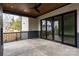 Covered patio with concrete flooring, sliding glass doors, and ceiling fan at 308 Dover Ave, Charlotte, NC 28209