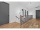 Light-filled hallway with hardwood floors and a modern staircase at 308 Dover Ave, Charlotte, NC 28209