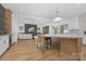 Open concept kitchen with island seating, custom cabinetry and a view into the living area at 308 Dover Ave, Charlotte, NC 28209