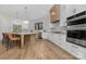 Modern kitchen featuring white cabinetry, stainless steel appliances, and a large island at 308 Dover Ave, Charlotte, NC 28209