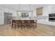 Modern kitchen with stainless steel appliances, a large island, and light hardwood floors at 308 Dover Ave, Charlotte, NC 28209