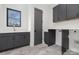 Modern laundry room with gray cabinets and hexagon tile floor at 308 Dover Ave, Charlotte, NC 28209