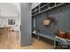 Mudroom with gray shiplap, built-in bench and view of kitchen at 308 Dover Ave, Charlotte, NC 28209