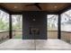 Screened porch with a modern fireplace and concrete flooring at 308 Dover Ave, Charlotte, NC 28209