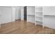 Bright walk-in closet with custom built-ins and hardwood floors at 308 Dover Ave, Charlotte, NC 28209