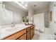 Bright bathroom with a bathtub, shower, and wood vanity at 3101 Elmwood Dr, Monroe, NC 28110