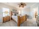 Main bedroom with wood frame bed, ceiling fan, and ensuite bathroom access at 3101 Elmwood Dr, Monroe, NC 28110