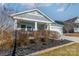 Gray house with white garage door, landscaping, and a porch at 3101 Elmwood Dr, Monroe, NC 28110