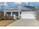 Gray house with white garage door, stone accents, and landscaping at 3101 Elmwood Dr, Monroe, NC 28110