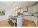 Bright kitchen boasts an island with seating, white cabinets, and stainless steel appliances at 3101 Elmwood Dr, Monroe, NC 28110