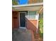 Inviting front door entrance with brick facade and storm door at 3103 Minnesota Rd, Charlotte, NC 28208