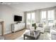 Living room with large windows, comfortable seating, and a modern media cabinet at 3608 Masonboro St # A, Charlotte, NC 28206