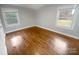 Bright bedroom with hardwood floors and large windows at 4616 Whispering Oaks Dr, Charlotte, NC 28213