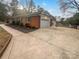 Side view of home with attached garage and driveway at 4616 Whispering Oaks Dr, Charlotte, NC 28213