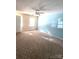 Carpeted bedroom with light blue accent wall and a window at 4663 Old Lantern Way, Charlotte, NC 28212