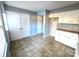 White kitchen cabinets and appliances, tile floor, and ample storage at 4663 Old Lantern Way, Charlotte, NC 28212