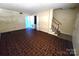 Carpeted living room with neutral walls and staircase access at 4663 Old Lantern Way, Charlotte, NC 28212