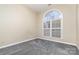 Bedroom with grey carpet and arched window with shutters at 4907 Foxbriar Trl, Charlotte, NC 28269