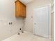 Laundry room features wood cabinets and built-in shelving at 4907 Foxbriar Trl, Charlotte, NC 28269