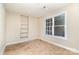 Small office space with tile flooring and built-in shelving at 4907 Foxbriar Trl, Charlotte, NC 28269