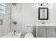 Clean bathroom with marble shower/tub surround and gray vanity at 503 Birch St, Lowell, NC 28098