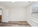 Simple bedroom with wood-look vinyl flooring, window, and neutral walls at 503 Birch St, Lowell, NC 28098