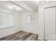 Cozy bedroom with wood-look vinyl flooring, window blinds, and neutral walls at 503 Birch St, Lowell, NC 28098